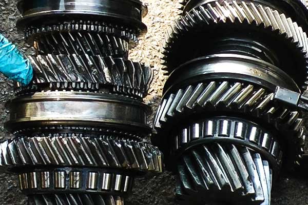 close up view of a gearbox layshaft with two gears that have several stripped teeth