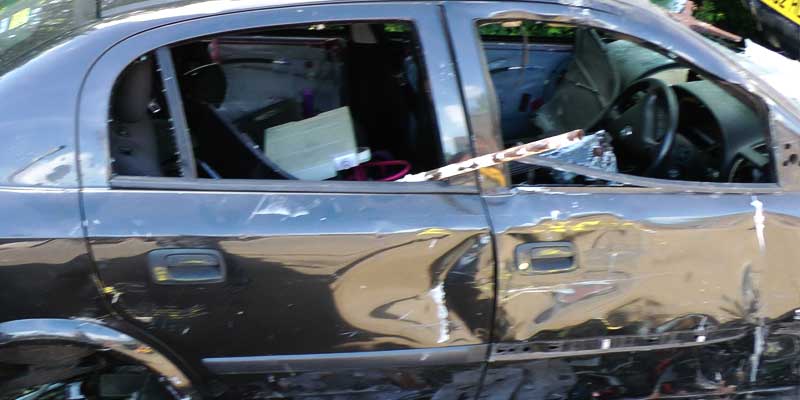 close up side view of an accident damaged car ready for scrapping