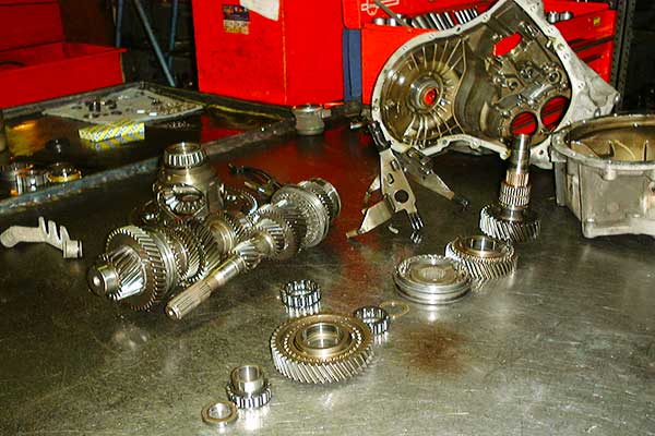 close up view of a fully dismantled gearbox including casin gears shafts and bearings