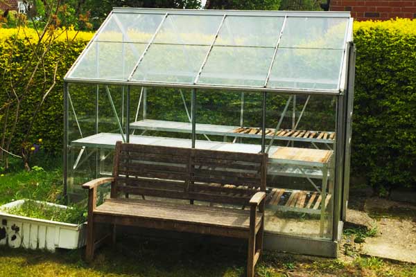 close up view of an aluminium metal greenhouse in a bradford garden