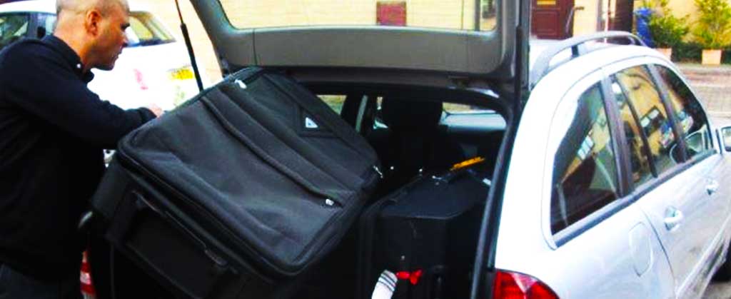 close up of an airport taxis unloading a customers luggage after a return airport trip