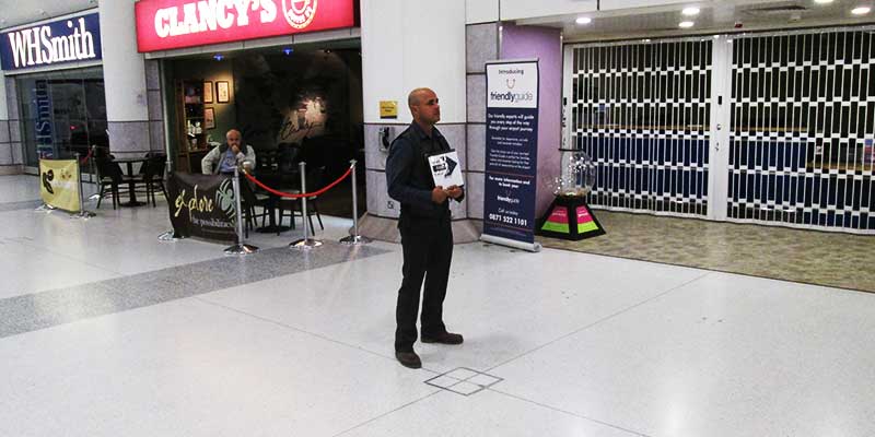 distance view of an airport lounge meet and greet service with atlantic airport travels driver holding a sign with the cutomers name on