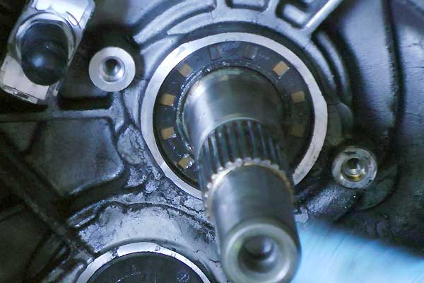 close up view inside a ford gearbox bell housing showing the main shaft with oil leaking from its seal