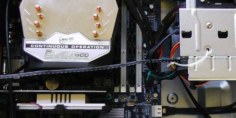 close up corner internal view of a newly built high specification computer showing the motherboard along with a very large processor heatsink and system memory