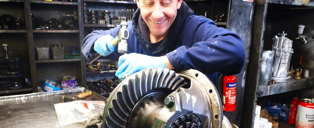 distance view of an m and t transmissions differential expert dismantling a ford differential to be reconditioned