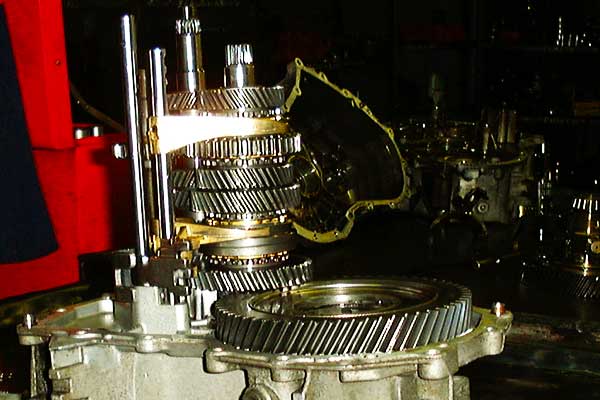 Gearbox Being Reconditioned close up view of a partially dismantled gearbox with all the internal workings still instact showing the various gears, shafts and bearings in subdued dramatic lighting