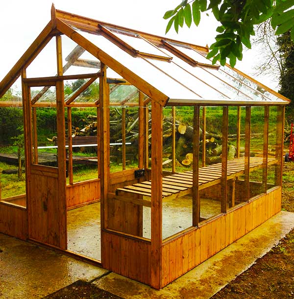 distance front corner view of a newly installed greenhouse