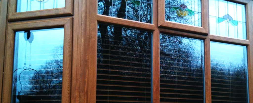 close up corner view of installed medium oak hardwood double glazing