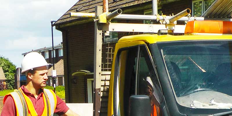 close up of brooks scaffolder climbing into his van havin successfully erected scaffold around a family home ready for roofing work to commence