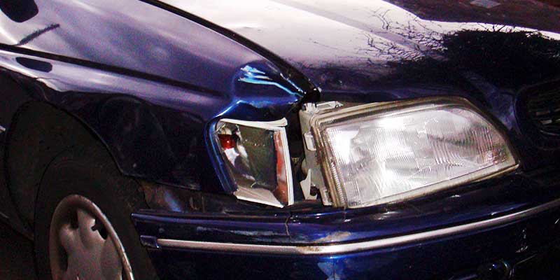 close up corner view of an old damaged car on its way to be scrapped by howarths scrap men