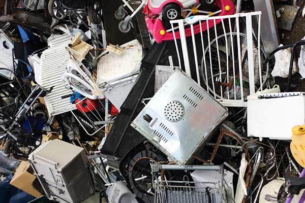 huge pile of typical domestic scrap items such as appliances toys sinks and bikes