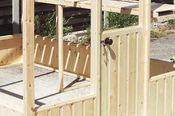 close up of a greenhouse built from untreated wood showing its bright natural whiteness